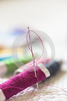 Spools of colorful thread, needle