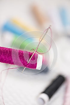 Spools of colorful thread, needle