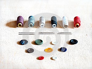 Spools with colorful thread, needles and buttons