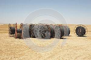 Spools Of Irrigation Hose On Arid Landscape