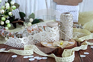Spools with lace trim and baker`s twine. Laces and trims. Crafting and sewing supplies