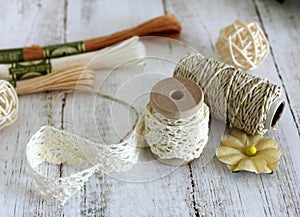 Spools with lace trim and baker`s twine. Laces and trims. Crafting and sewing supplies. Embroidery threads.