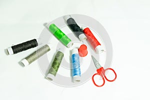 Spools of multi-colored threads and scissors