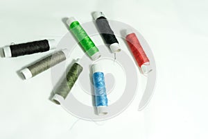 Spools of multi-colored threads and scissors