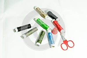 Spools of multi-colored threads and scissors