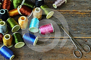 Spools of multicolored threads and scissors