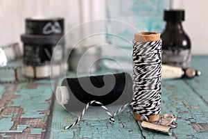 Spools with thread and baker`s twine. Black and white threads