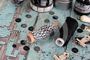 Spools with thread and baker`s twine. Black and white threads