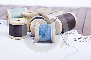 Spools of thread with a needle on a napkin