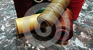 Spools of thread over stone surface