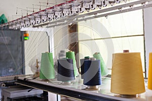 Spools of thread in the sewing equipment in fabric industry. Sewing production