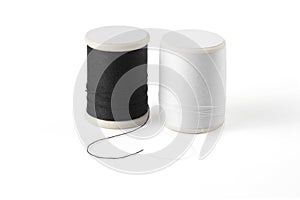 Thread spool on a white background. Basic color of thread: White, Black.