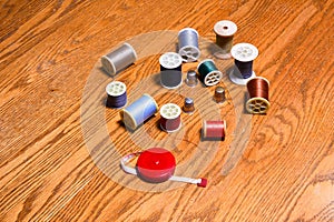 Spools of thread, thimbles, and a tape measure
