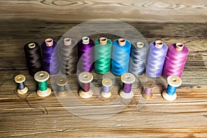 Spools of thread on wooden background. Old sewing accessories. c