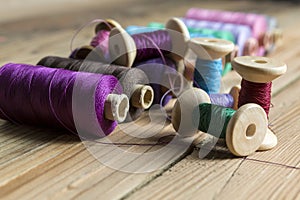 Spools of thread on wooden background. Old sewing accessories. c