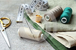 Spools of threads and sewing tools on light table
