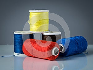 Spools of various colored threads for knitting