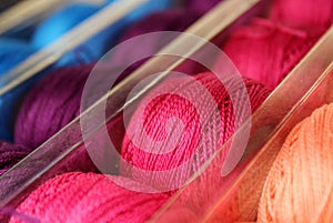 Spools of Vibrantly Colored Thread in Rows