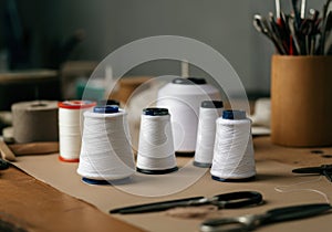 Spools of white thread arranged on a crafting table for sewing projects