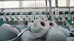 Spools of yarn thread in a basket. Textile factory equipment. Textile factory. Spinning production. Yarn making