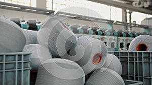 Spools of yarn thread in a basket. Textile factory equipment. Threads production. Textile factory. Spinning production