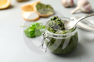 Spoon with basil pesto sauce and space for text