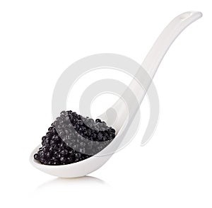 Spoon with black sturgeon caviar isolated on white background