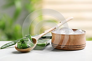 Spoon and bowl with pieces of aloe vera