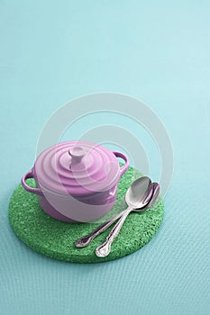 Spoon and ceramic cup on pastel background