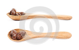 Spoon of chocolate candies isolated
