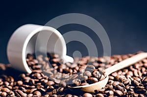 Spoon of coffee beans. Background. Energy. Raw coffee beans. Grained product. Hot drink. Close up. Harvesting. Natural