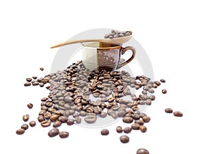 Spoon of coffee beans on a cup isolated (selective focusing at spoon)