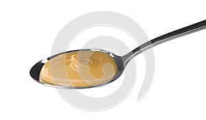 Spoon of delicious peanut butter on white background