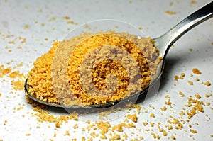 A spoon of delicious yellow cookie powder