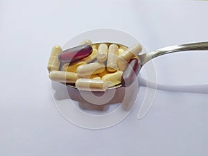 Spoon with dietary supplements.