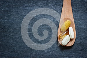 Healthy supplements on wooden spoon