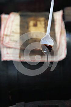 Spoon dripping very old Balsamic Vinegar of Modena