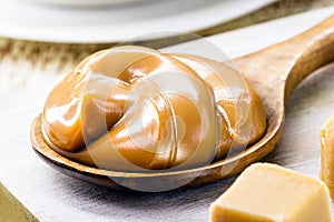 spoon of dulce de leche or homemade sweet caramel, called Dulce de lethe in Brazil, typical food of the June festivities