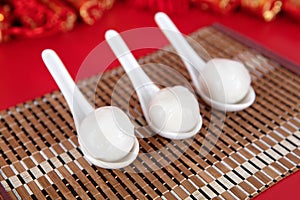 Spoon with dumplings on the red background