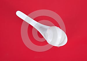 A spoon with dumplings on the red background