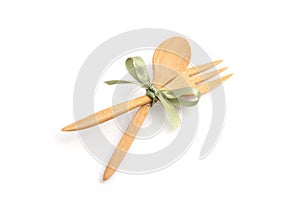 Spoon and fork with bow ties on white background