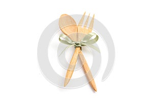 Spoon and fork with bow ties on white background