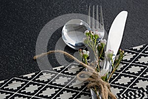 Spoon, fork, butter knife and flower tied up with rope