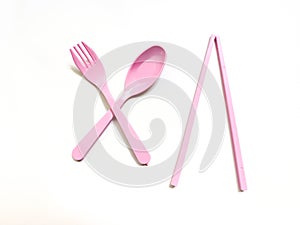 Spoon, fork, and chopsticks on a clean white background