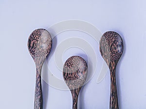 Spoon and fork kitchen utensils set handmade from coconut tree and bamboo wooden on white background.