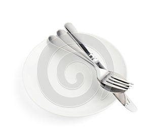 Spoon, fork and knife over the white plate