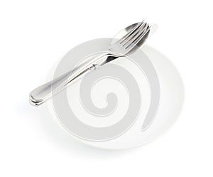 Spoon, fork and knife over the white plate