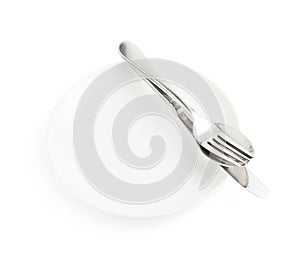 Spoon, fork and knife over the white plate