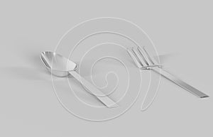 Spoon and fork made of metal on a gray background.