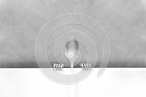 Spoon and forks depicting a person at a table
